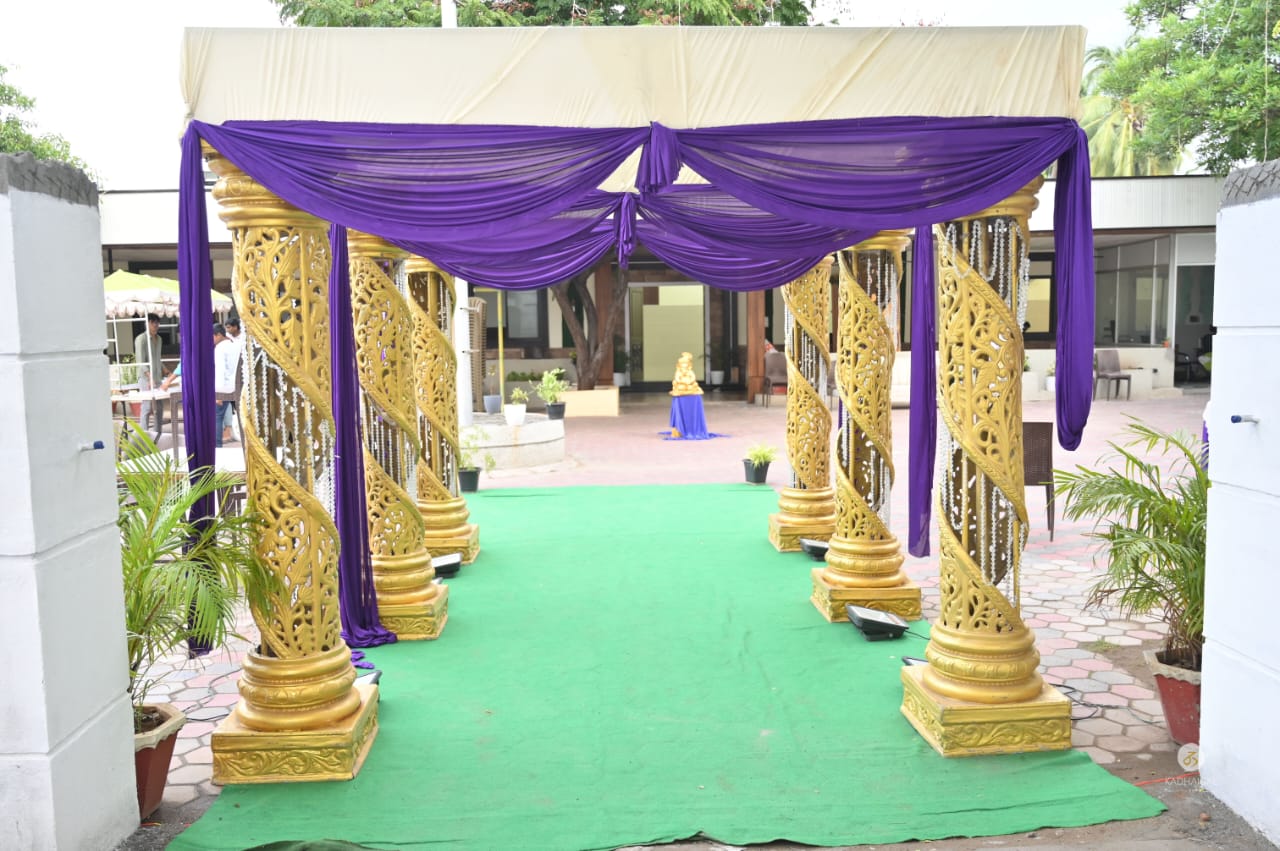 Golden entrance pillars with draped decor at Karu Function Hall